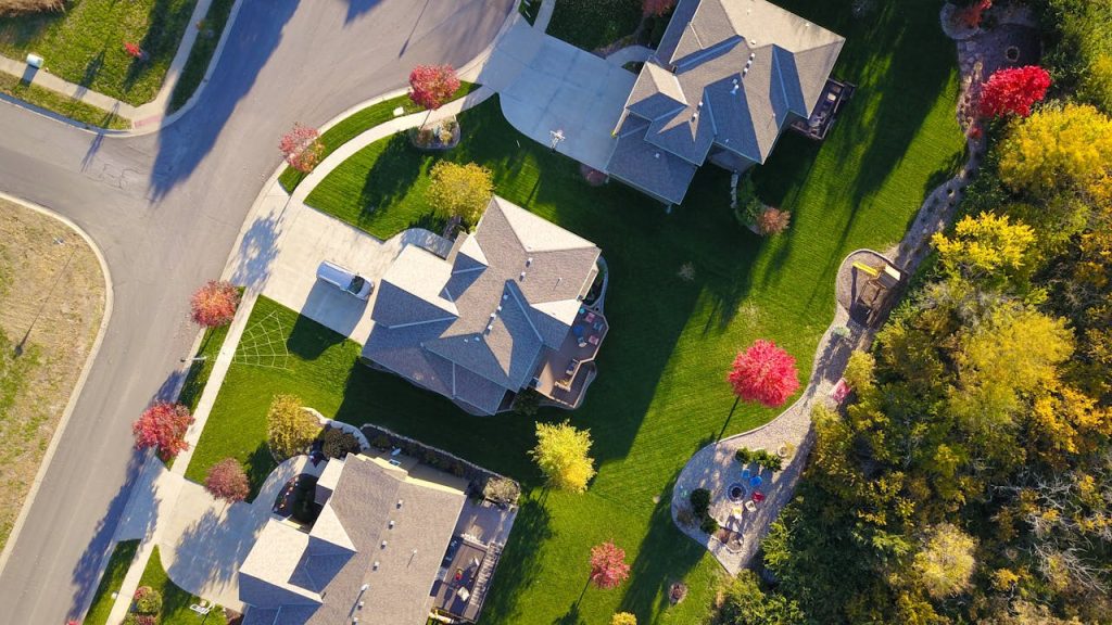 Aerial view of suburban neighborhood with autumn trees.