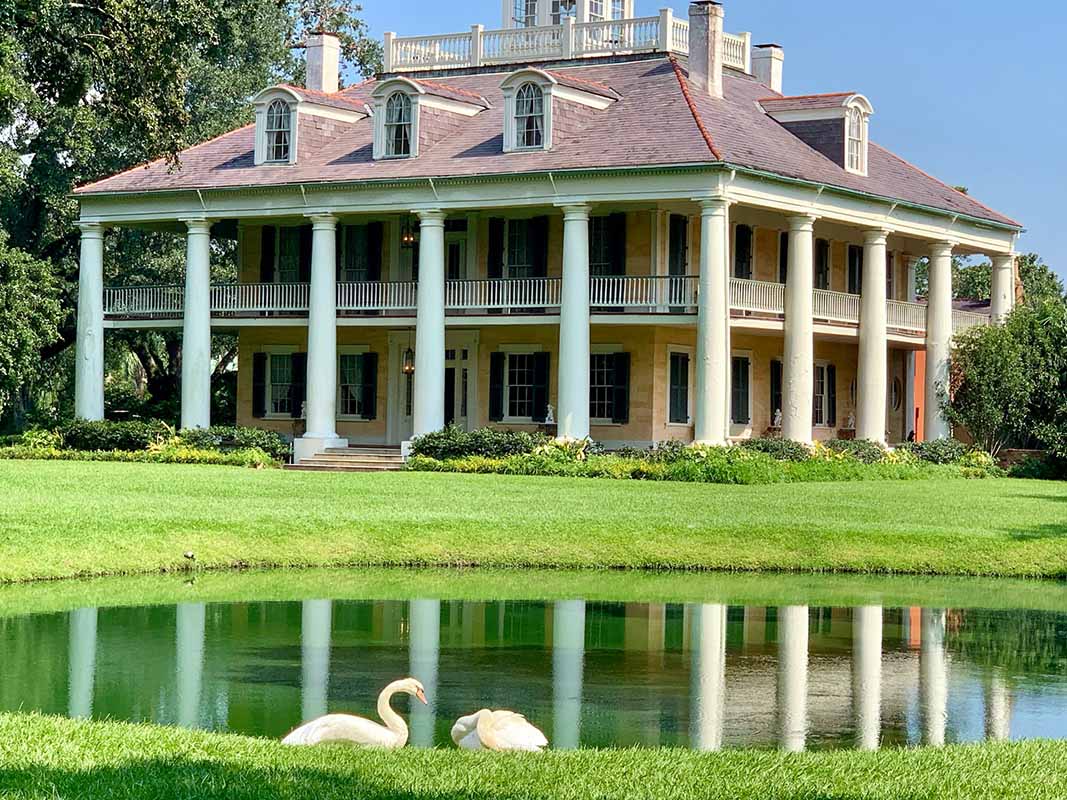 Griffin Lawn Care Services Geismar, Louisiana Historic mansion with columns by pond and swans.